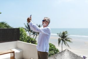senior-man-on-vacation-taking-a-selfie-YRT5B3V-300×200